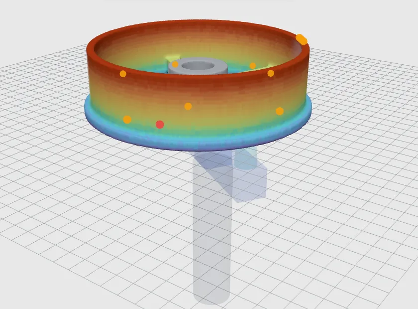 QCast low-pressure die-cast wheel coloured from blue to red by fill time, above its riser tube.